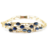 Armband mit 12x blauen Saphiren und Diamanten 585 Gelbgold
