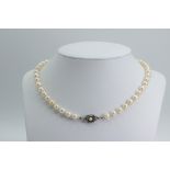 Pearl necklace with silver clasp.