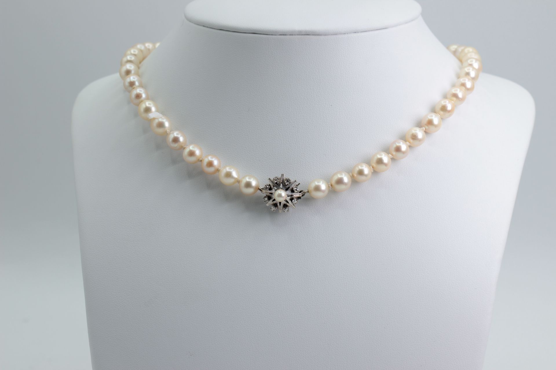 Akoya pearl necklace with white gold clasp, stamped 585. Clasp has 8 small diamonds, with a pearl