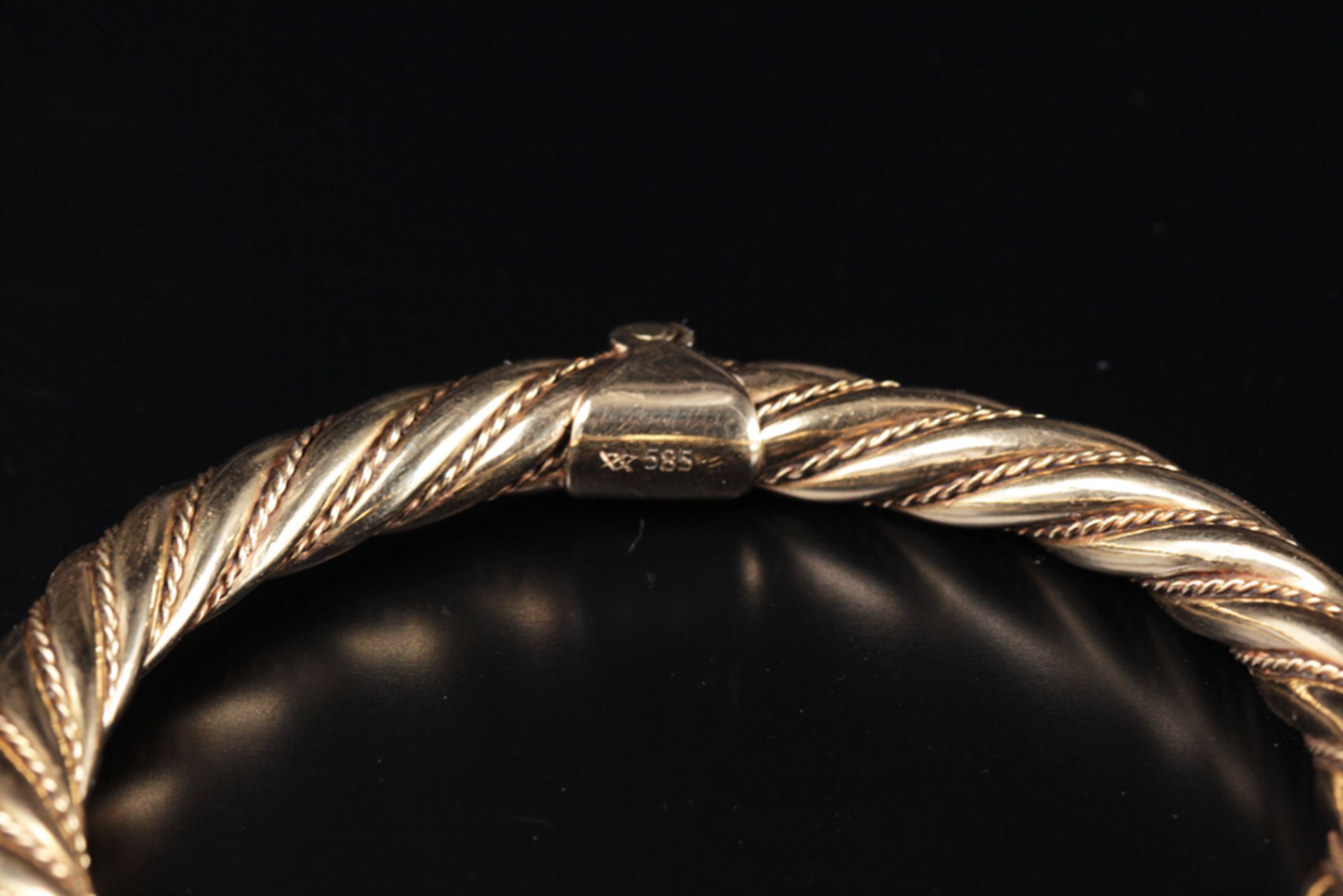 The bangle is made of twisted gold wires and has round spheres at the end.The spheres have a - Image 2 of 4