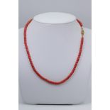 Antique coral necklace with gold clasp.