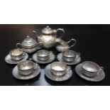 Dolls Accessories - a Victorian pewter dolls house tea service, comprising teapot, six teacups and