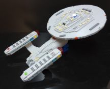 A Lego Enterprise NCC-1701-C Starship by Model Moc Building; other display models of Enterprise