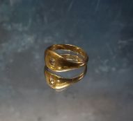 An 18ct gold signet ring set with a round diamond approx. 1/16th of carat, 4.35g gross