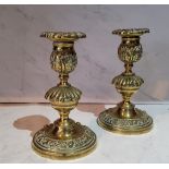 A pair of post Regency bronze candlesticks, the sconces cast with floral border, knopped stems,