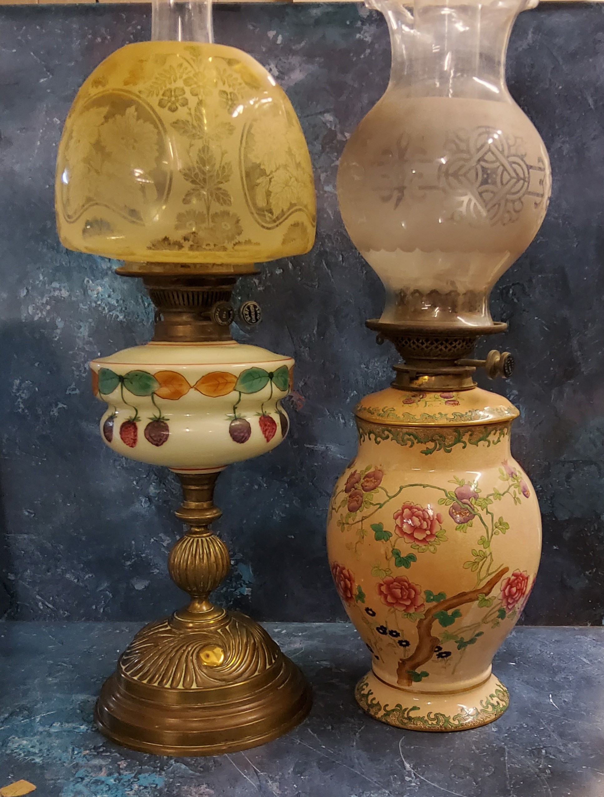 An Andrews and Co early 20th century oil lamp, milk glass reservoir, painted with berries and