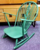 An Ercol 'fleur de lys' rocking chair, painted green c.1970