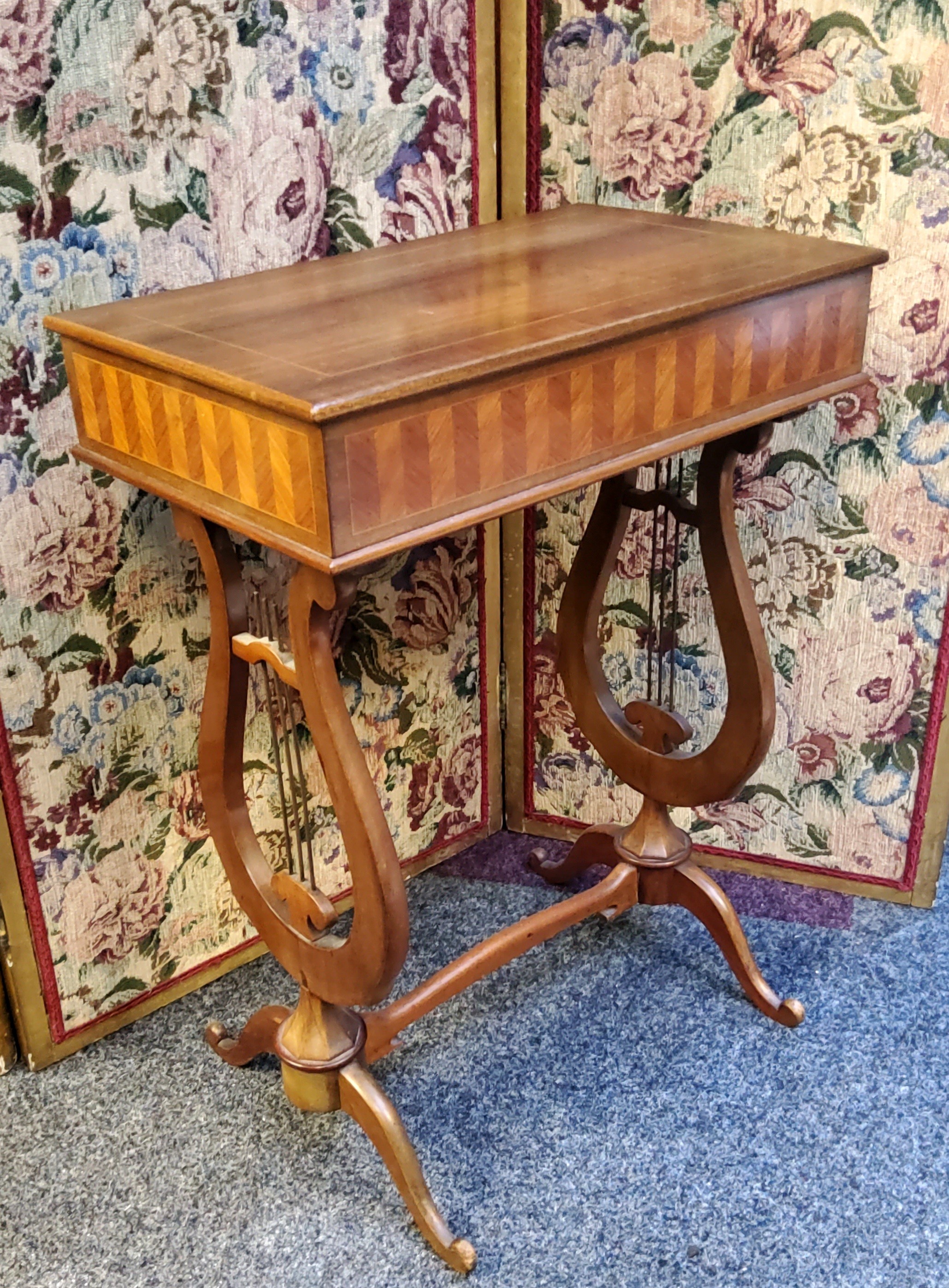 A reproduction mahogany sewing table, the side inlaid with parquetry bands,  lyre shape supports,