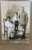 An Edwardian family portrait, the little boy holding a scratch built model of a ship, the other