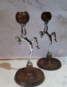 A pair of Art Deco oak and chrome plated figural candlesticks, with naked ladies holding the
