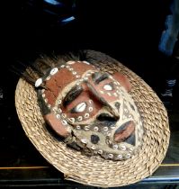 Tribal Art - a Papua New Guinea mask, painted and applied with feathers and cowrie shells, 35cm high