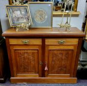 An Edwardian mahogany side cabinet, with two drawers above two carved and fielded panelled doors,