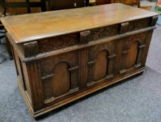 A Titchmarsh & Goodwin carved oak Tudor style blanket box, with original sale label, 118cm wide x