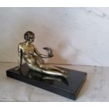 Art Deco, a silvered bronze, a lady with a bird, reclining, black rectangular marble base, 22cm wide