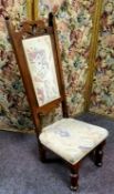 An Arts & Crafts oak prie-dieu style nursing chair c.1910