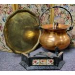 A copper cauldron shaped fuel bin, swing handle, 36cm high  a large brass tray table top, 58cm wide;
