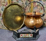 A copper cauldron shaped fuel bin, swing handle, 36cm high  a large brass tray table top, 58cm wide;