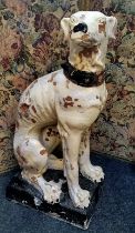 An over painted crackle glazed on terracotta seated greyhound, sitting approximately 90cm high
