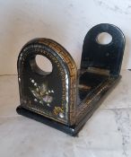 A Victorian papier mache sliding bookrack, inlaid in abalone with Lily of the Valley, 33cm wide, c.