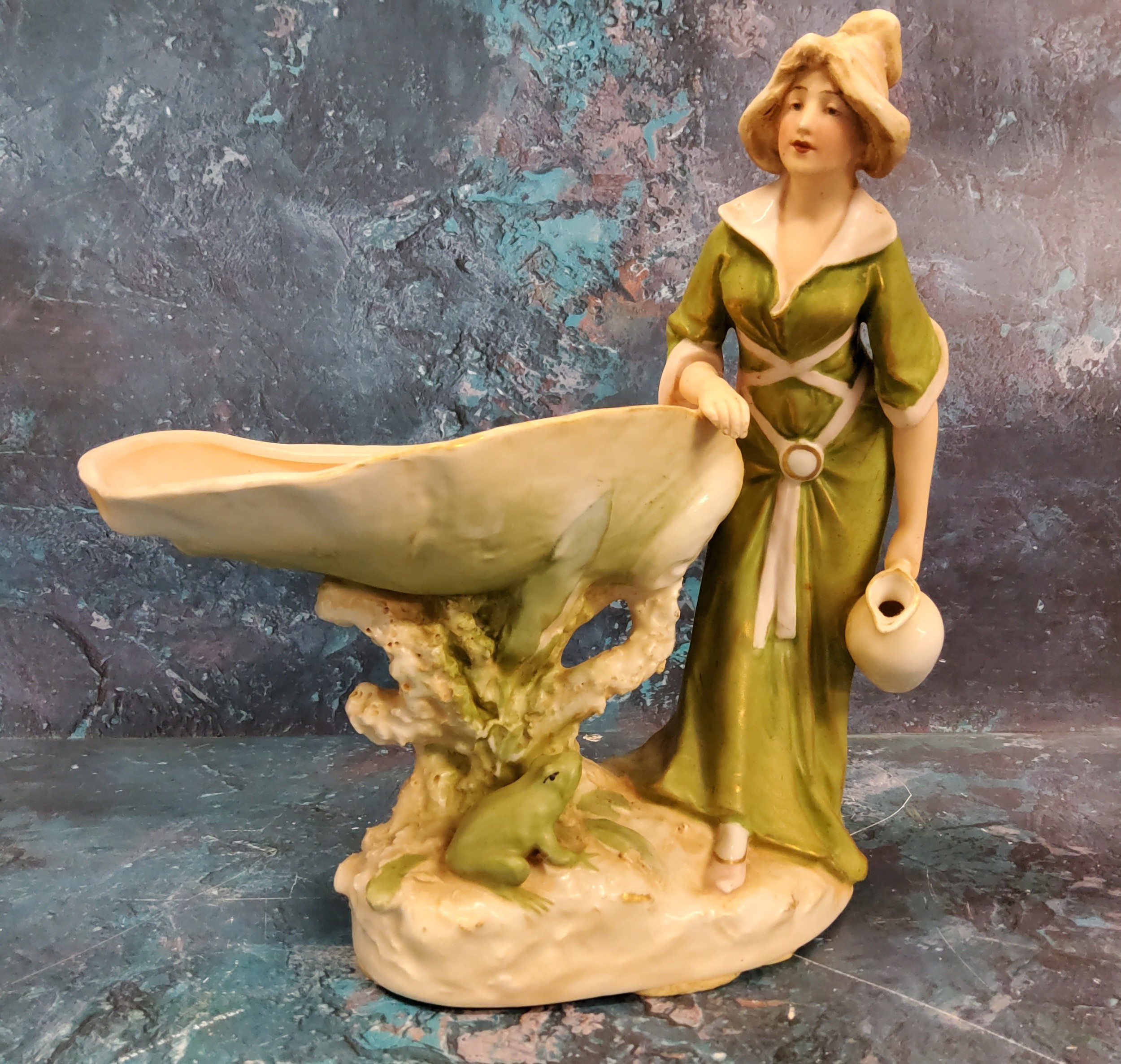 A Royal Dux figure, of a maiden standing by an oversize shell and frog, 22cm high, pink triangle