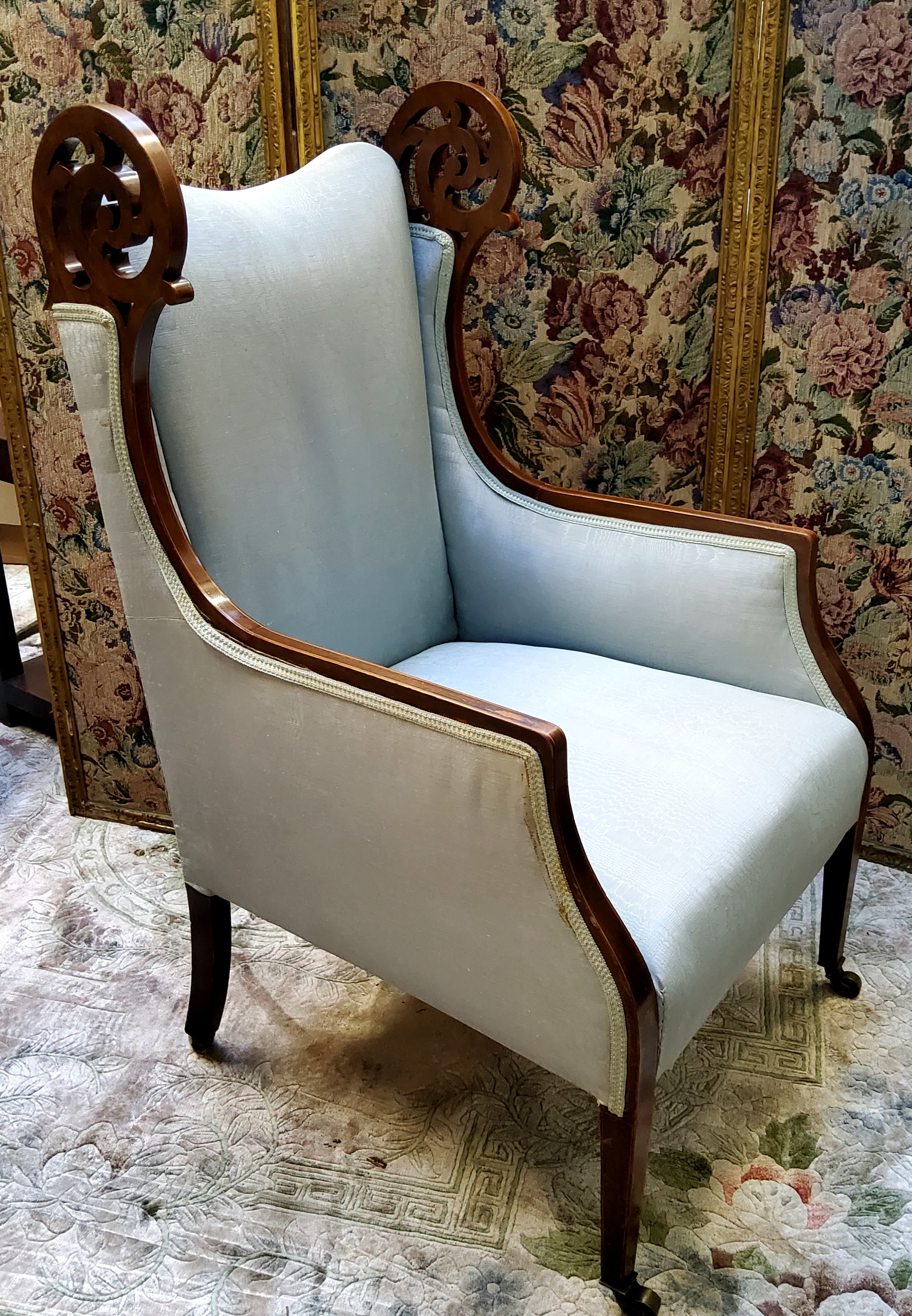 An Edwardian walnut wingback armchair, satinwood inlaid stringing in watermark silk type