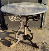 An early 20th century cast iron and marble topped circular table