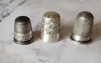 A silver thimble, engraved with foliage, Charles Horner; others (3)