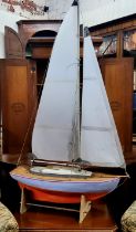 A scratch built wooden pond yacht, with masts, sails and rigging, with painted hull and deck, 63cm