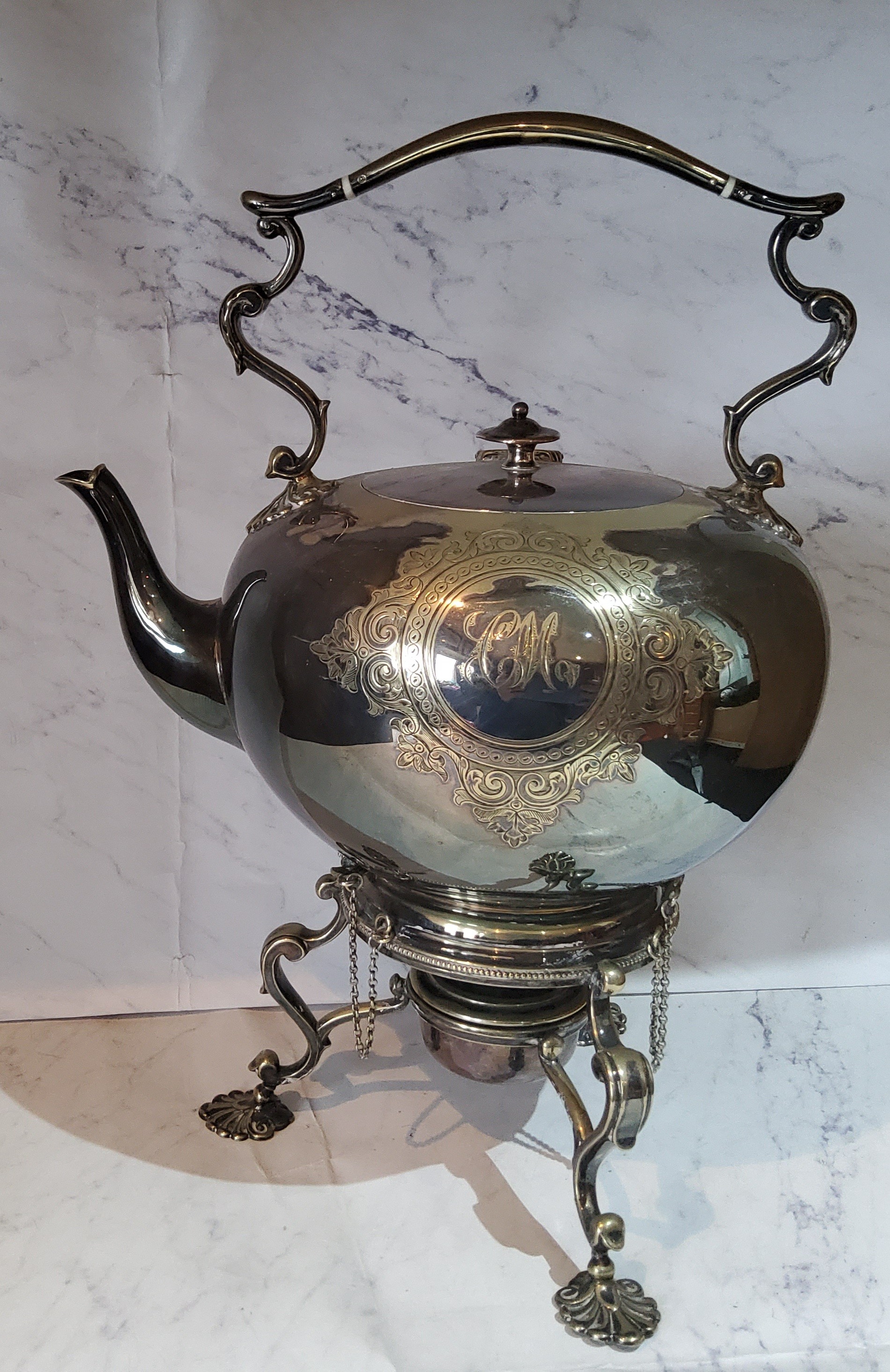 A Victorian E.P.N.S. globular spirit kettle on stand, engraved with circular cartouche and scrolling