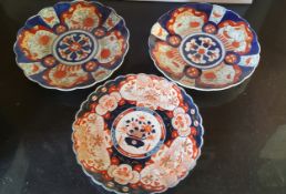 A pair of Japanese shaped circular Imari chargers, decorated in the typical palette, 30cm diam,