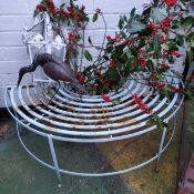 A painted metal demilune garden seat; lantern and heron sculpture (3)