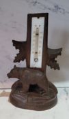 An early 20th century Black Forest thermometer, the base with a bear, inscribed Lugano, 18cm high,