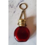 A Victorian ruby glass chatelaine scent bottle, hinged cover, suspension chain, 5cm high, c.1860