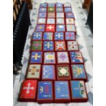 A harlequin set of fourty ecclesiastical hassocks / worshipping prayer stools, each with unique