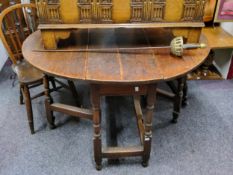 An 18th century oak gateleg oval drop-leaf dining table, drawer to frieze, 74cm high, 120cm wide,