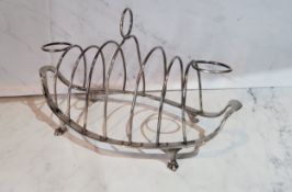 A George III Old Sheffield Plate Neo-classical boat shaped seven bar toast rack ring loop handle,