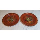 A pair of 19th century shaped circular papier mache wine coasters, painted with flowers, 16.5cm