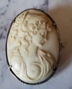 A Victorian silver mounted cameo brooch, carved with a scantily clad lady, 4.25cm high, c.1860