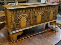 A Titchmarsh & Goodwin oak blanket box, carved with three arches and egg and dart details, bracket