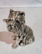 A silver model of a West Highland Terrier, paw raised, 6cm high, filled