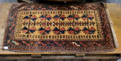 A small 19th century hand woven Caucasian prayer rug in tones of deep blue, ochre and brown, 90cm