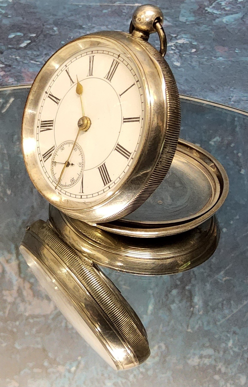 A silver cased open faced pocket watch, unmarked Swiss movement, white enamel dial , black Roman