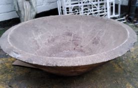 A substantial reconstituted dished saucer shaped garden planter