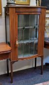 An Edwardian Sheraton Revival mahogany bow fronted display cabinet, satinwood stringing, the