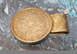 An unusual money clip, mounted with a Morgan Dollar, dated 1901, the clip chased an engraved with