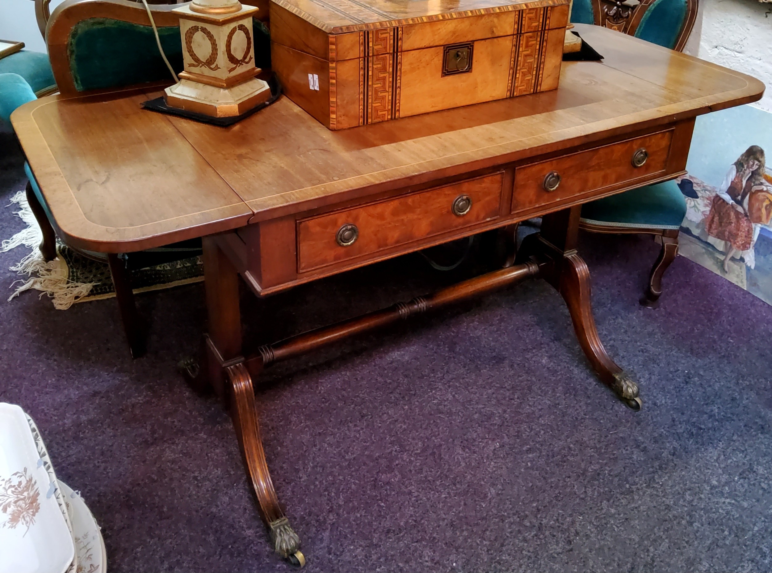 A Regency style mahogany and walnut sofa table, two short cockbeaded drawers to frieze, turned