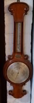 A Victorian mahogany onion top barometer, silvered dial, inscribed Finnigans Manchester, mercury