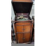 An early 20th century oak cased Gilbert  gramophone,  in cabinet, 110cm high, 52cm deep, c.1935