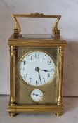 A 19th century brass carriage alarm clock, Arabic numerals, alarm dial, swing handle, 14cm high,