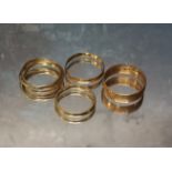 A 9ct rose gold band, size O, 2.16g; a 9ct three gold Russian wedding ring, size O, 1.89g; a